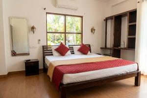 a bedroom with a large bed with a large window at Samudra heritage in Cochin +31 photos