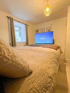 a bedroom with a bed with a laptop on it at Charming 1-Bed on High St in Longwell Green