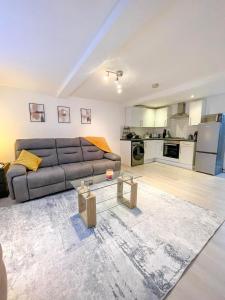 a living room with a couch and a table at Charming 1-Bed on High St in Longwell Green