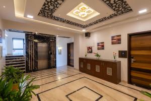 a lobby with a door and a staircase in a building at Hotel Altitude Coorg in Madikeri