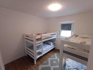 a bedroom with two bunk beds and a window at Villa Una Verde in Bosanska Krupa