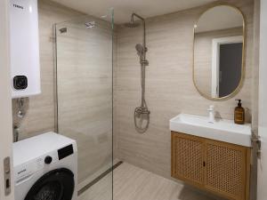 a bathroom with a shower and a sink and a mirror at Kalelarga in Betina +35 photos