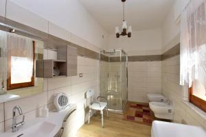 a bathroom with two sinks and a shower at Appartamento Vacanza in Mògoro +45 photos