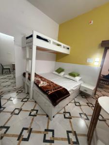 a bedroom with a bunk bed in a room at Colonel Cottage in Prayagraj