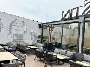 a mural of a woman on the side of a restaurant at Besstin Hotel in Hisār