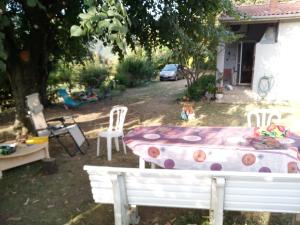 a table and chairs in the backyard of a house at La simonde in Malarce-sur-la-Thines +3 photos