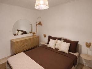 a bedroom with a large bed and a mirror at Kalelarga in Betina