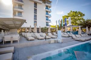 a hotel pool with lounge chairs and a gazebo at ELIA MARe Hotel ALL Inclusive - Free Beach Access in Kiten
