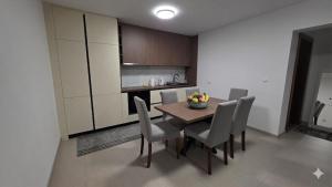 a dining room with a table and chairs in a kitchen at Apartment Real in Bugojno