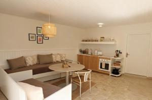 a living room with a couch and a table at Kalelarga in Betina