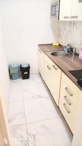 a kitchen with white tile floors and a sink at Neu-Isenburg in Neu Isenburg
