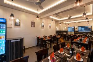 a restaurant with tables and chairs and a bar at Hotel Altitude Coorg in Madikeri
