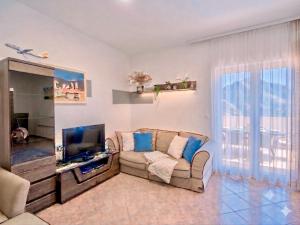 a living room with a couch and a flat screen tv at Apartments Djurovic in Kotor