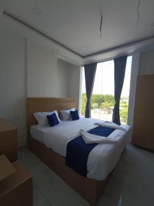 a bedroom with a large bed with a window at VRK Comfort in Mysore
