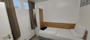 a small bedroom with a bed in a room at Neu-Isenburg in Neu Isenburg