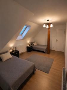 a attic bedroom with two beds and a window at Wynajem pokój kinga Kujawska in Sztutowo