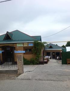 a building with a sign on the front of it at Guest House 777 in Türkistan