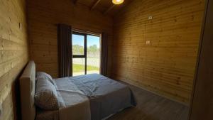 a bedroom with a bed in a room with a window at IL Paradiso in Kavajë