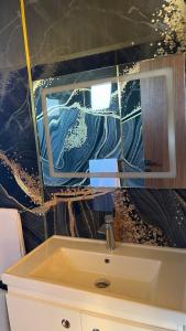 a bathroom with a sink and a mirror at IL Paradiso in Kavajë