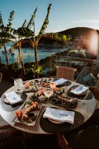 a table with food on it with a view of the ocean at Saint Nicolas Hotel in Himare