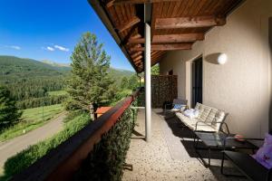 a porch with a couch and a view of a mountain at Zirbitzblick in Mönchegg