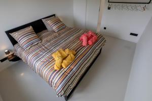 a bed with two pairs of clothes on it at Het Meer in Rotselaar +11 photos