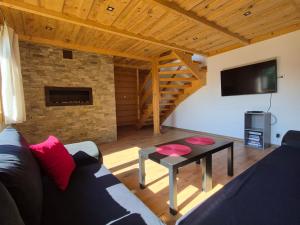 a living room with a couch and a table at NowiNowe Domki in Dzianisz