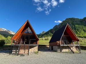 a couple of small houses with mountains in the background at Gagma Chalets Kazbegi in Kazbegi