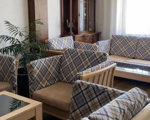 a living room with couches and tables at Hotel Iceberg Bansko in Bansko