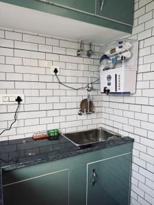 a kitchen with a sink and a microwave at The Second Home , Chamba Hills in Chamba +11 photos