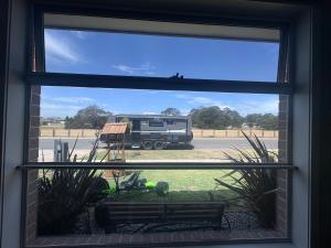 a window view of a truck in a parking lot at Park Views Guest Room in Kilmore