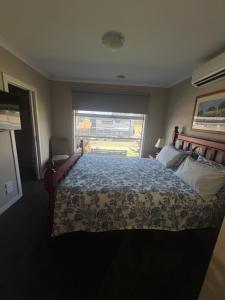 a bedroom with a large bed and a window at Park Views Guest Room in Kilmore +4 photos