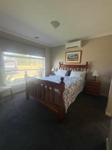 a bedroom with a large bed and a window at Park Views Guest Room in Kilmore