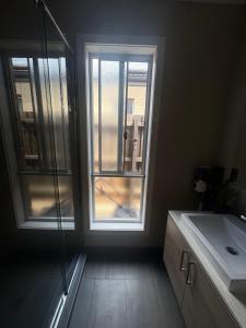 a bathroom with a sink and a glass window at Park Views Guest Room in Kilmore
