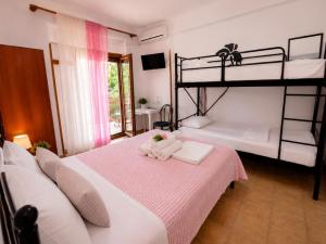 a bedroom with two bunk beds with towels at Gallery in Ammouliani
