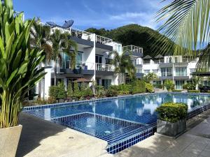 a large swimming pool in front of a building at Private pool villa in Kamala Beach