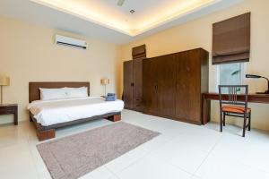 a bedroom with a bed and a desk and a chair at Private pool villa in Kamala Beach +45 photos