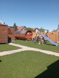 a park with a playground with a slide and a slideintend at Tinyhouse auf der Fischer-Ranch in Westerheim