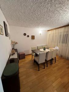a dining room with a table and chairs at Vacation house Dora in Malinska