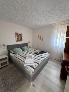 a bedroom with a large bed in a room at Vacation house Dora in Malinska