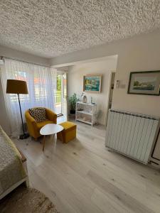 a living room with a couch and a table at Vacation house Dora in Malinska