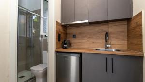 a small bathroom with a sink and a toilet at Fereniki Lemnos Suites in Platy +166 photos