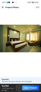 a screenshot of a hotel room with a bed at HOTEL The Breeze in Pachamba