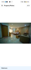 a living room with couches and tables in a room at HOTEL The Breeze in Pachamba