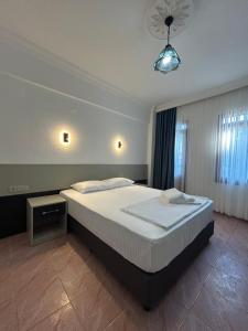 a bedroom with a large bed in a room at Ünlü Otel in Fethiye +22 photos