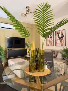 a living room with a glass table with a plant at DD apartments & suites in Paralia Katerinis