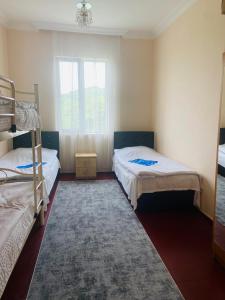 a bedroom with two bunk beds and a rug at Гостевой дом у Эмзара in Batumi +14 photos