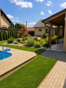 a yard with a swimming pool and a house at Penzion U Kyjovky, Týnec in Týnec