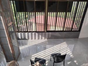 a view of a balcony with chairs and a window at Bliss Paradise Resort in Malvan