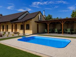 a swimming pool in front of a house at Penzion U Kyjovky, Týnec in Týnec